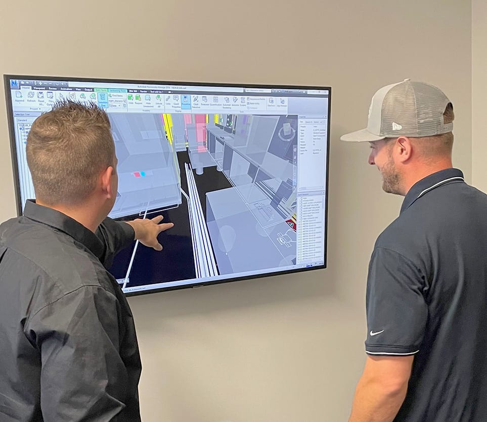 Two employees looking at BIM drawing on screen
